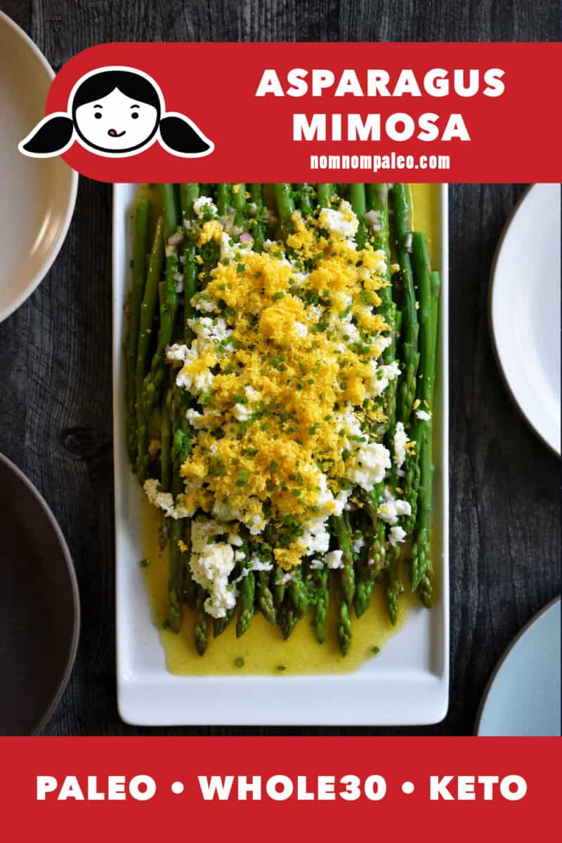 An overhead shot of asparagus mimosa on a rectangular platter, blanched asparagus topped with a zesty vinaigrette and sieved hard boiled eggs. The red banner on the bottom says paleo, Whole30, and keto.