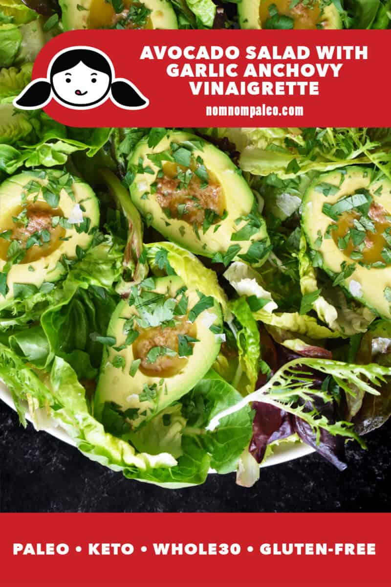 A shot of avocado salad with halved avocados filled with a garlic anchovy vinaigrette on mixed greens. There is a red banner at the bottom that reads paleo, keto, Whole30, gluten-free.