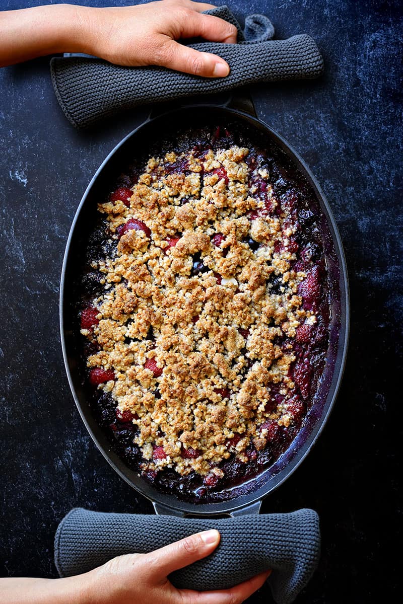 An overhead shot of a paleo and vegan berry crisp fresh out of the oven.