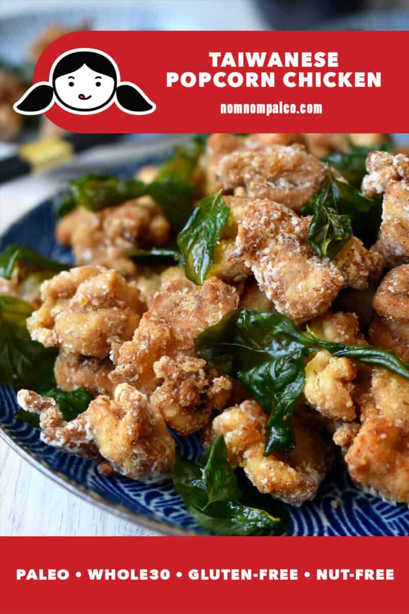 A close up of a platter of Taiwanese Popcorn Chicken with fried basil on a blue plate. A red banner at the bottom reads paleo, Whole30, gluten-free, and nut-free