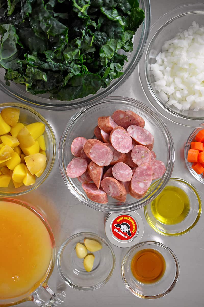 An overhead shot of the ingredients needed for sausage and kale soup.