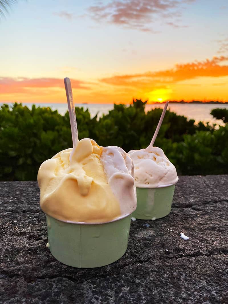 Two cups of gelato in front of Hawaiian sunset