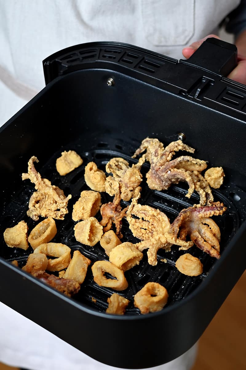 An air fryer basket filled with paleo, gluten-free, and Whole30 fried calamari
