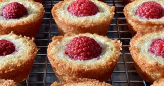 A close up of paleo and gluten free raspberry financiers on a cooling rack
