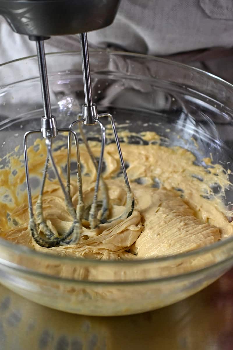 A mixer is combining the wet ingredients for paleo thumbprint cookies.