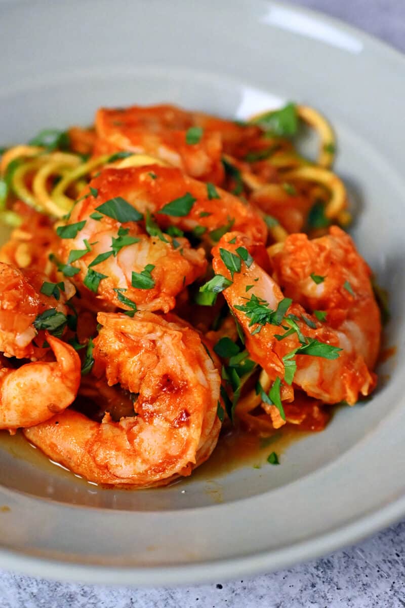 A closeup side view of Whole30, paleo, and keto spicy shrimp pasta with zucchini noodles.
