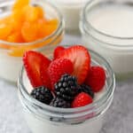 Four jars filled with paleo and dairy free coconut jelly desserts, a dairy-free Melo Melo copycat recipe