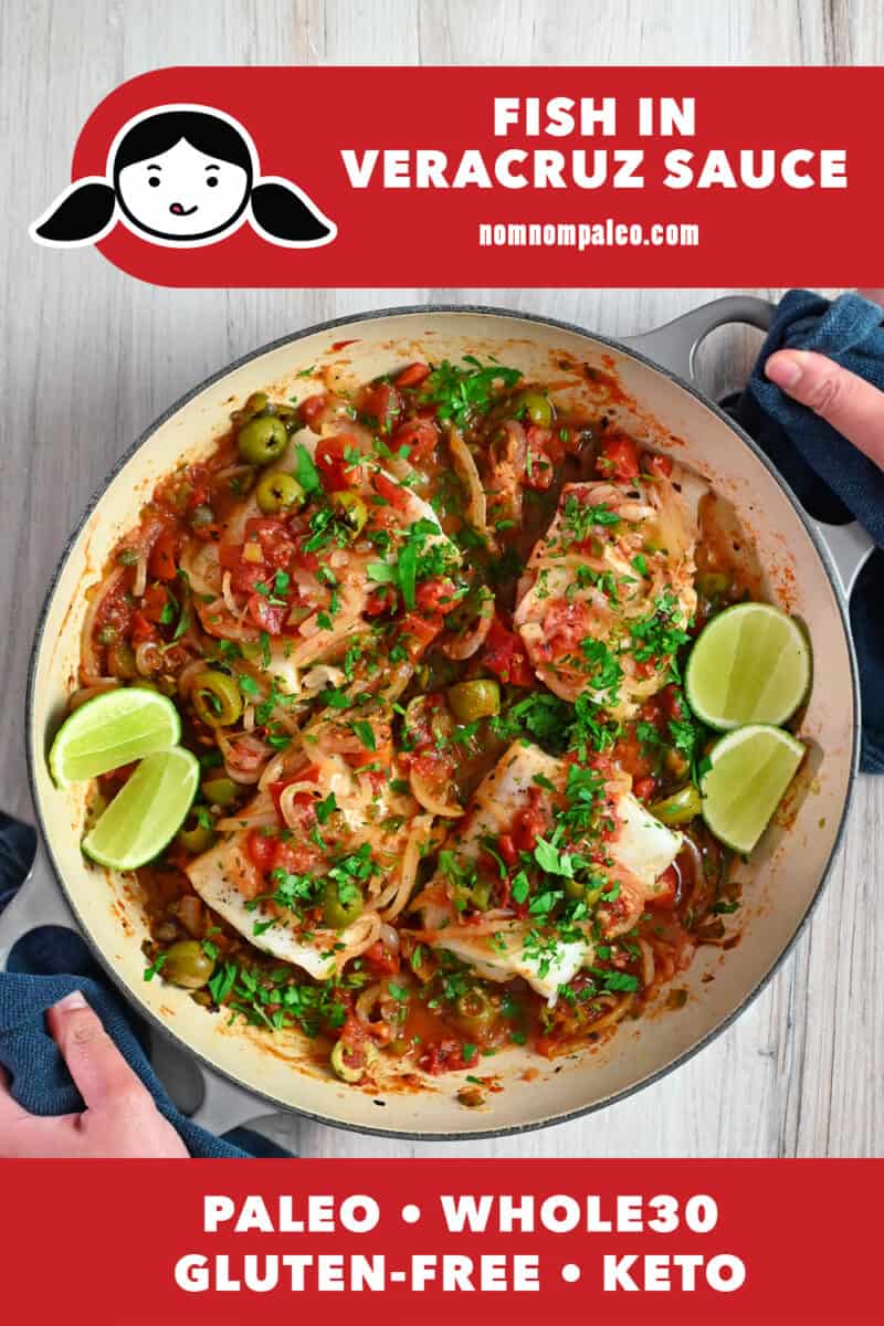 An overhead shot of a skillet filled with white fish in Veracruz sauce.