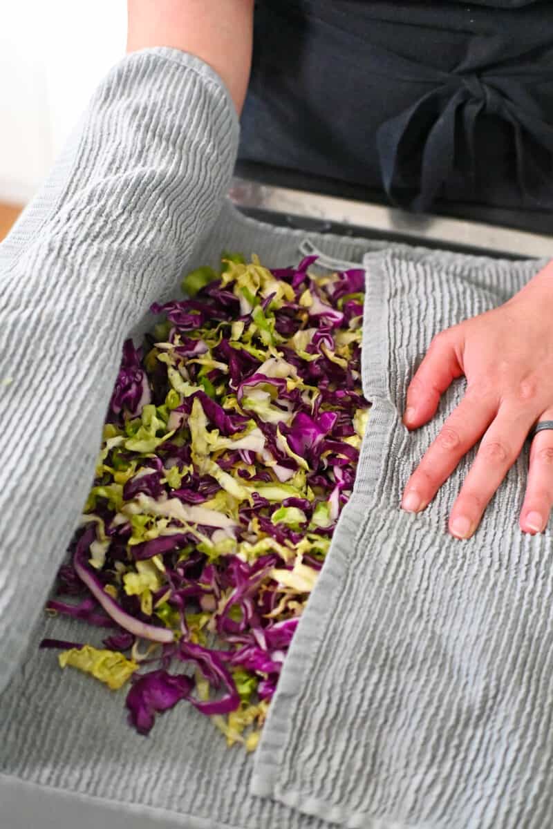 The wilted and salted cabbage is placed in a clean kitchen towel and pat dry.