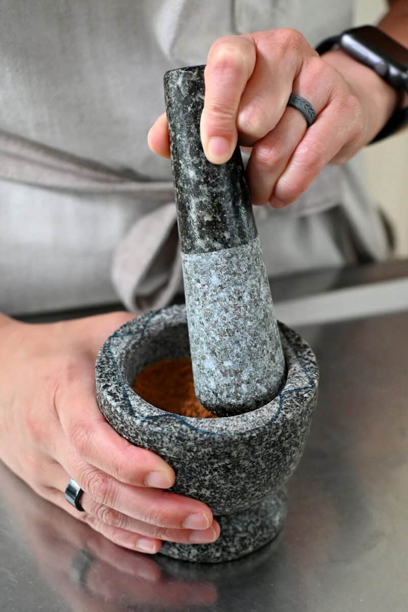 Crushing paleo cookies in a mortar and pestle.
