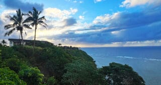 A sunset on the coast of Kauai. The text says Gluten-Free Kauai.