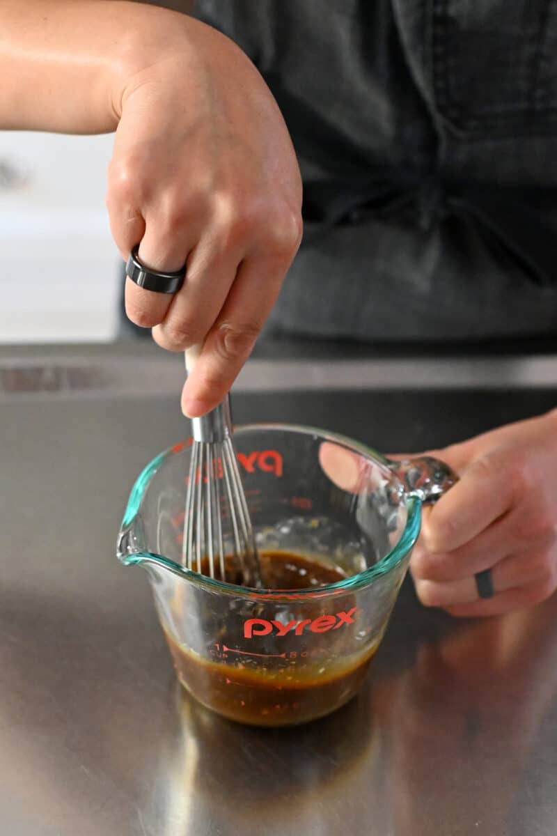 Whisking the sauce for Moo Shu Chicken in a liquid measuring cup.