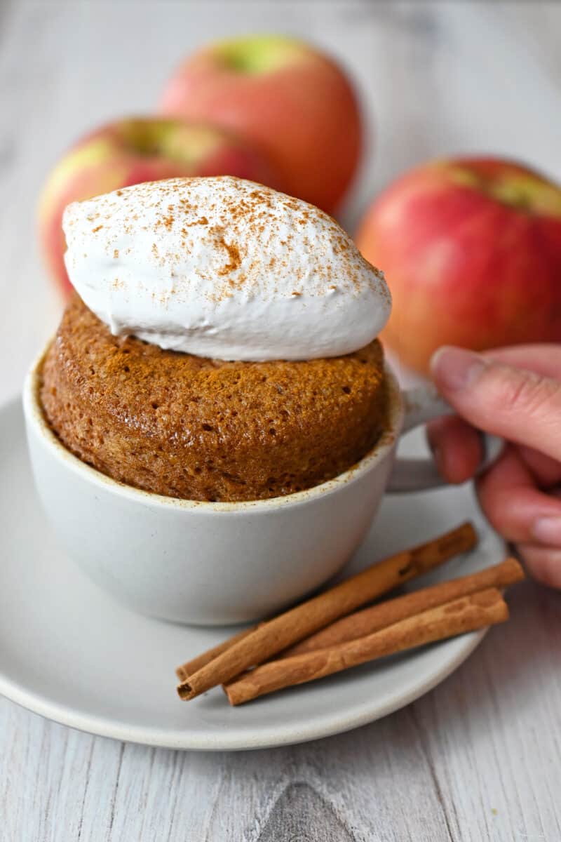 A side shot of a gluten free mug cake flavored with apple and cinnamon.