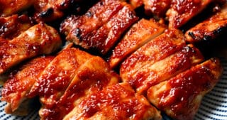 A plate of Char Siu chicken that is sliced up and ready to serve.