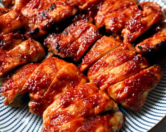 A plate of Char Siu chicken that is sliced up and ready to serve.
