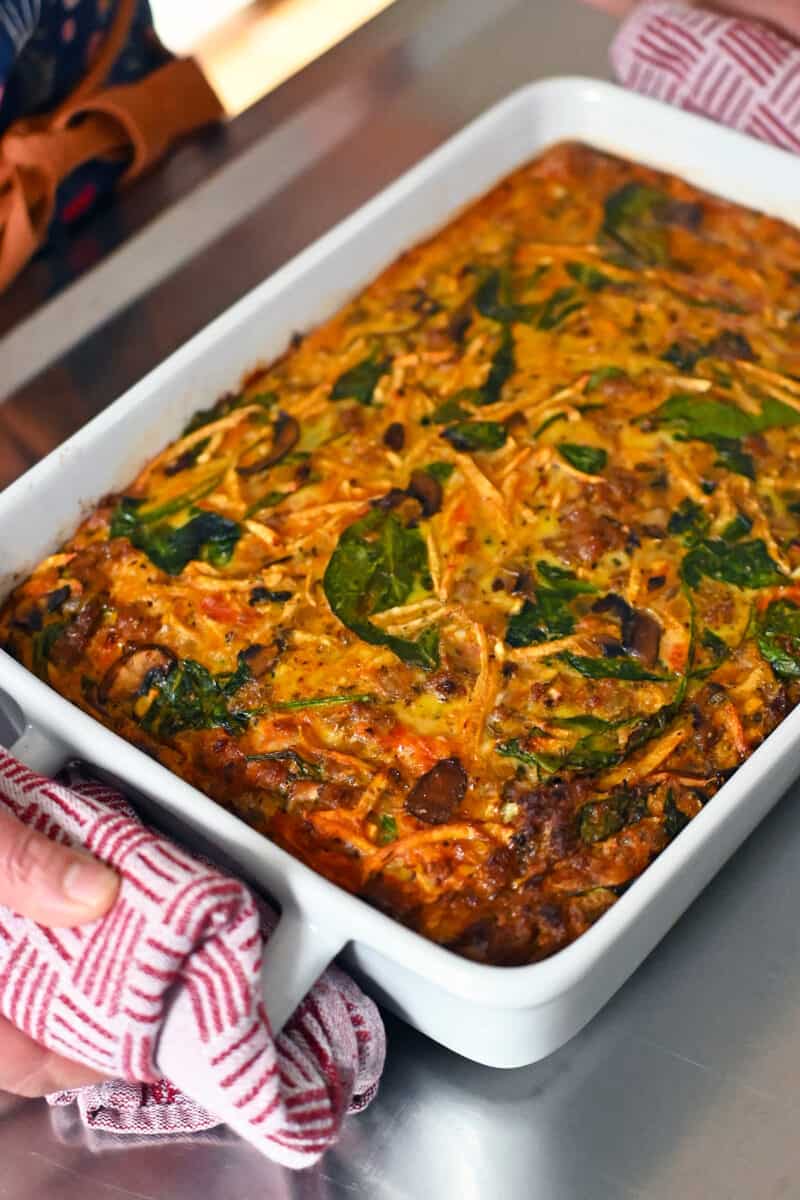 A sausage breakfast casserole out of the oven and on a stainless steel counter. 