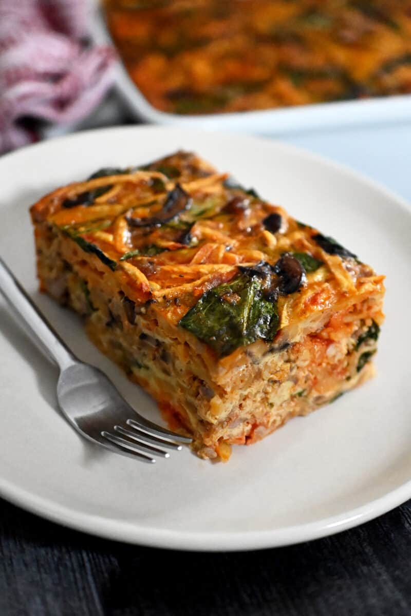 A slice of paleo and Whole30 sausage breakfast casserole on a white plate.