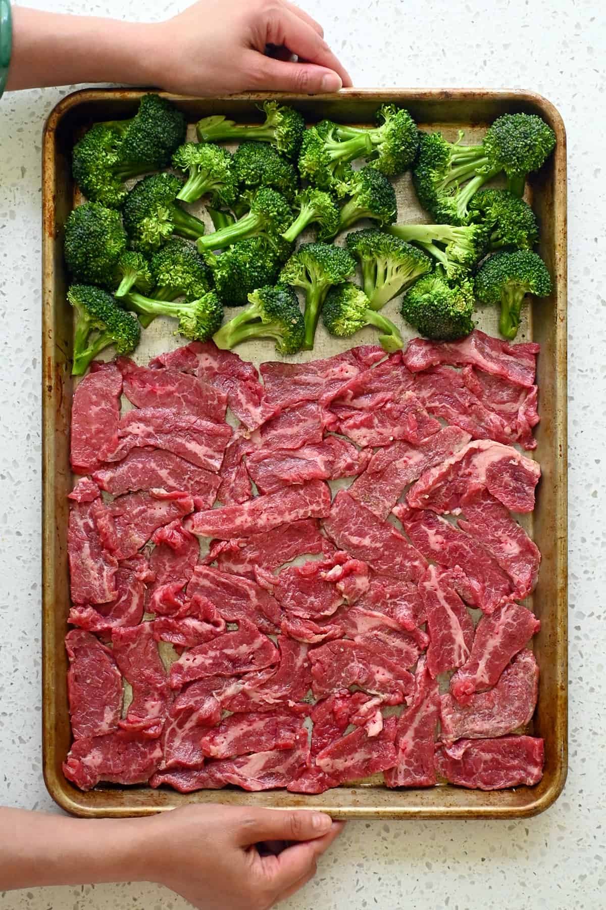An overhead shot of sheet pan beef and broccoli ready to go in the oven.