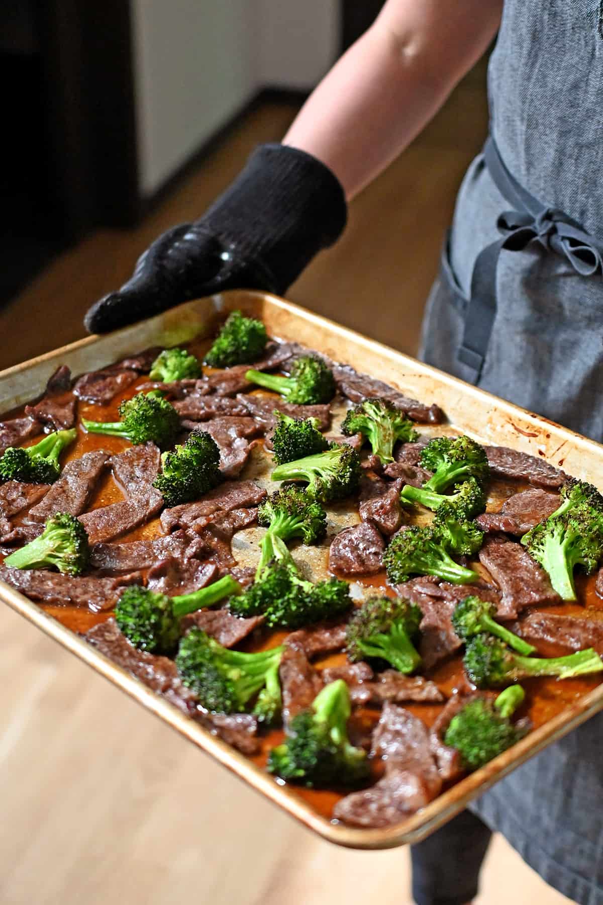A rimmed baking sheet filled with Chinese beef and broccoli right out of the oven.