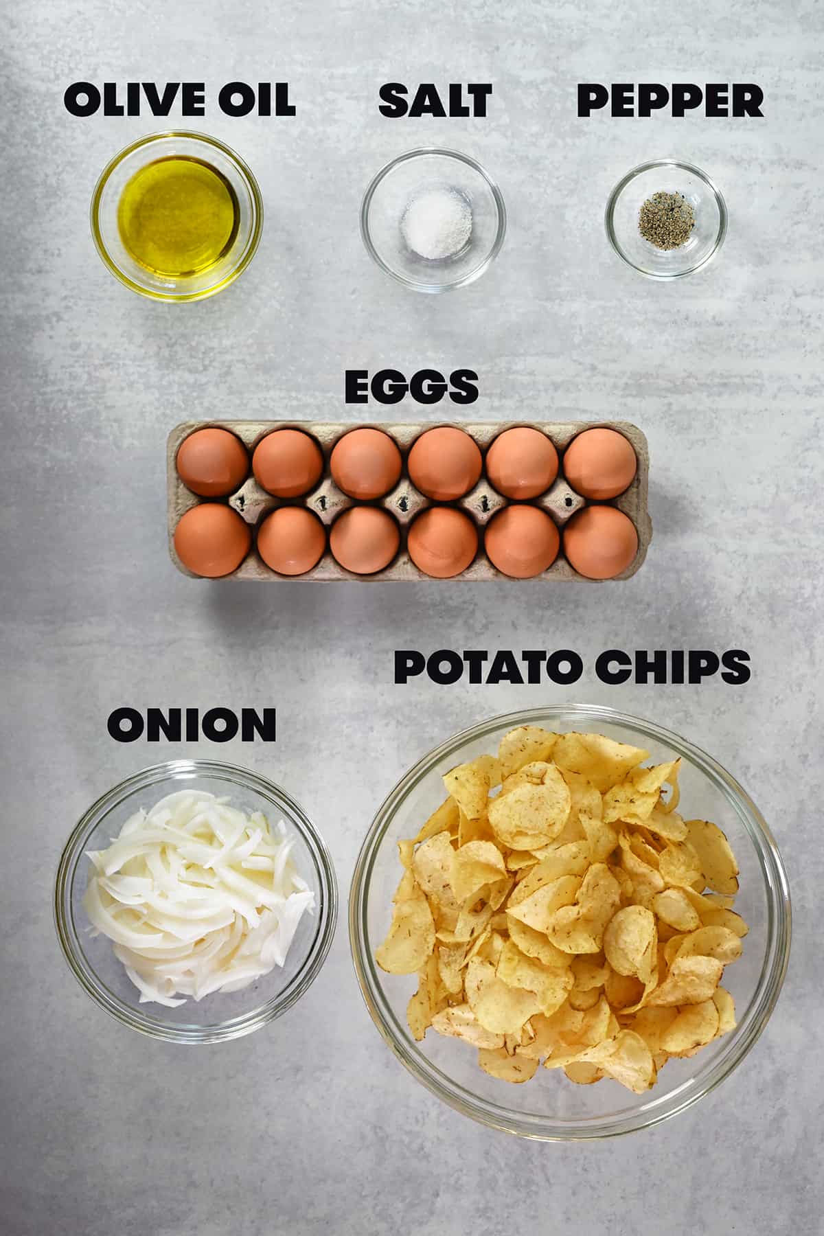 An overhead shot of the ingredients to make a Spanish tortilla, tortilla espanola, with potato chips.