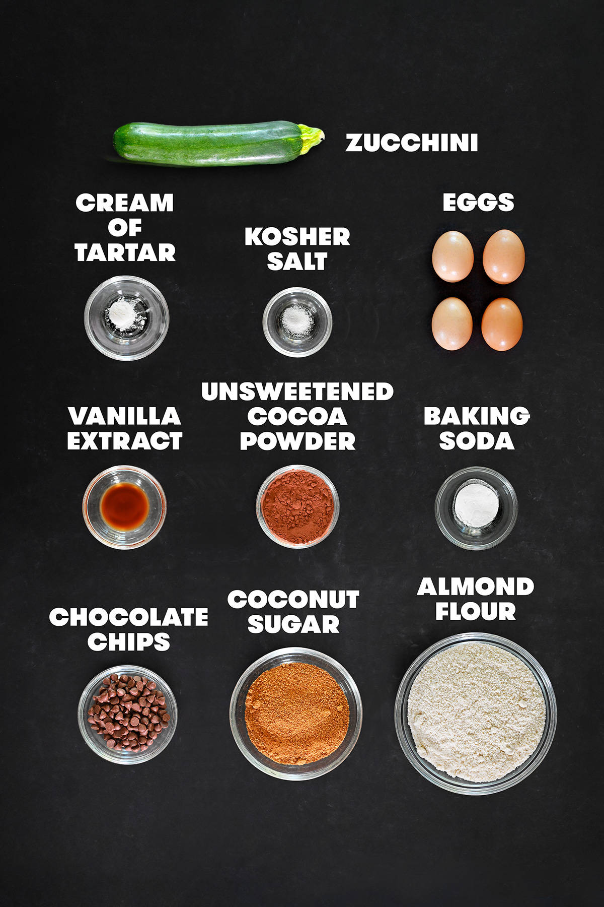 The raw ingredients measured out in bowls for paleo chocolate zucchini muffins.