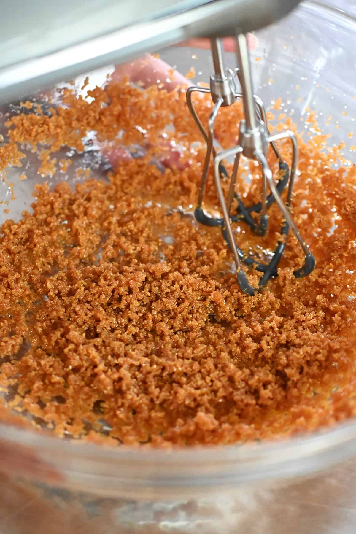 A closeup of the blended coconut sugar, coconut oil, and vanilla extract in a glass mixing bowl.