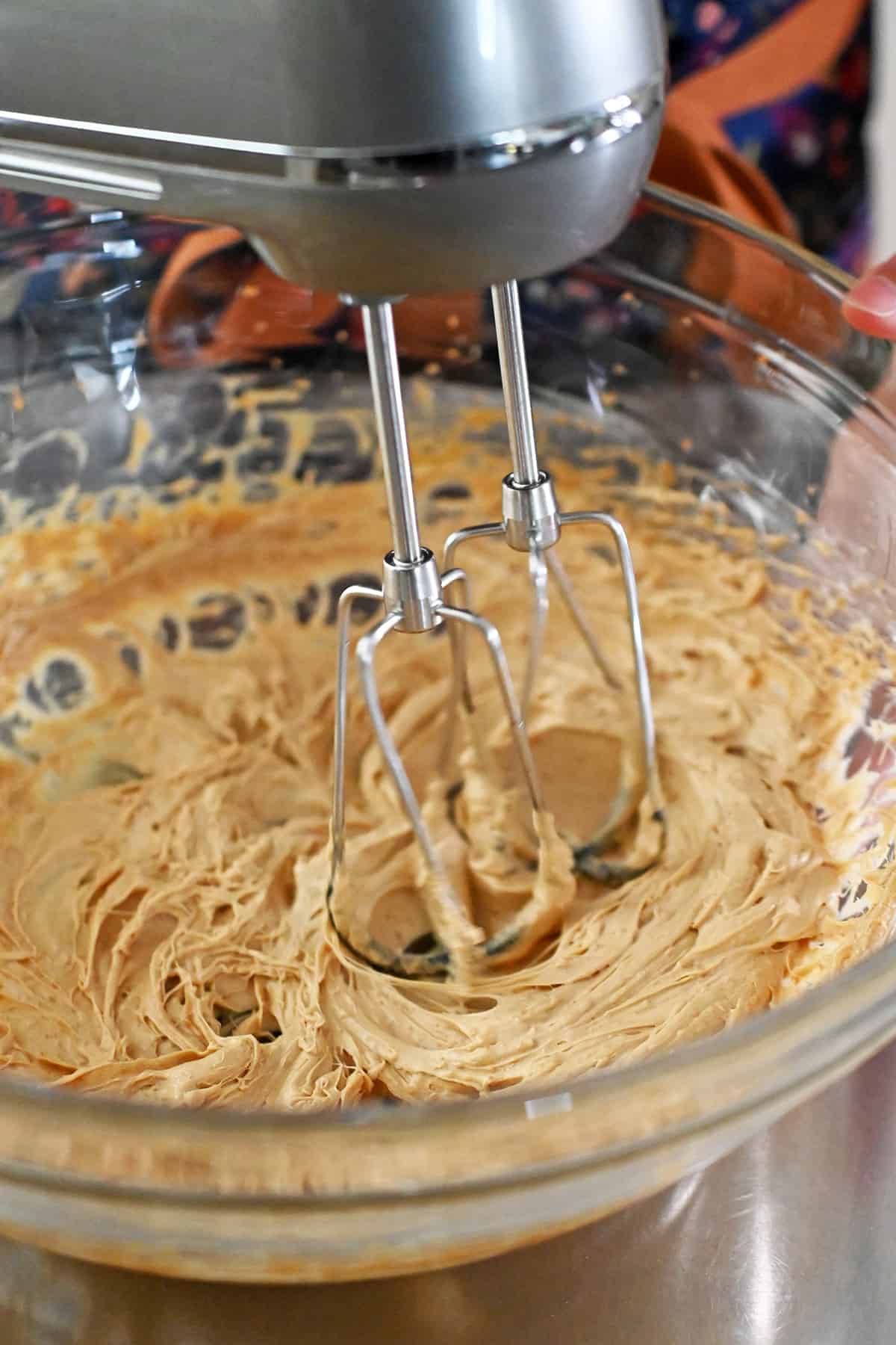The paleo and gluten free snickerdoodle batter is lighter in color after being mixed for 3 to 4 minutes with a hand mixer.