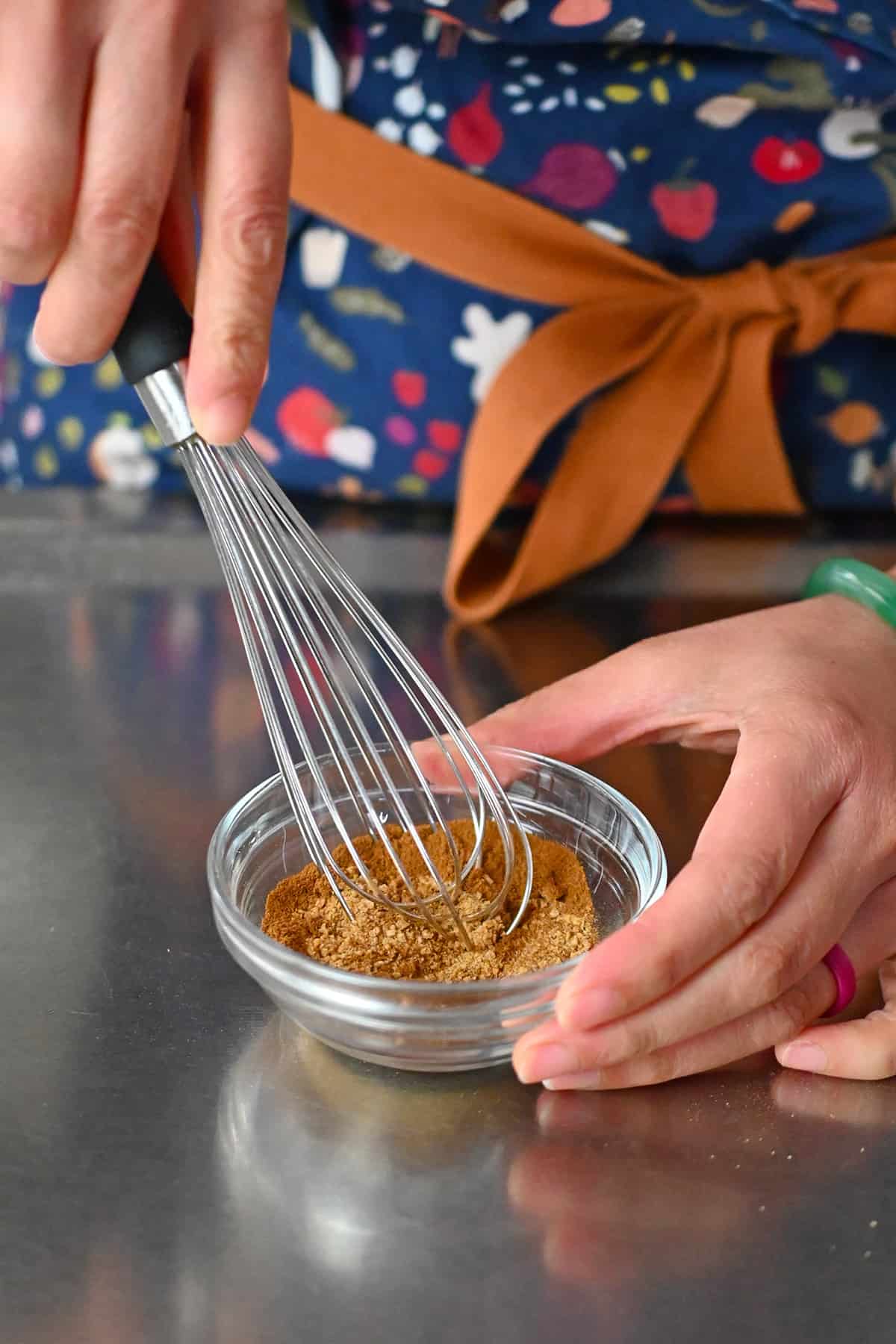 Using a whisk to blend the cinnamon sugar snickerdoodles coating in a small bowl.