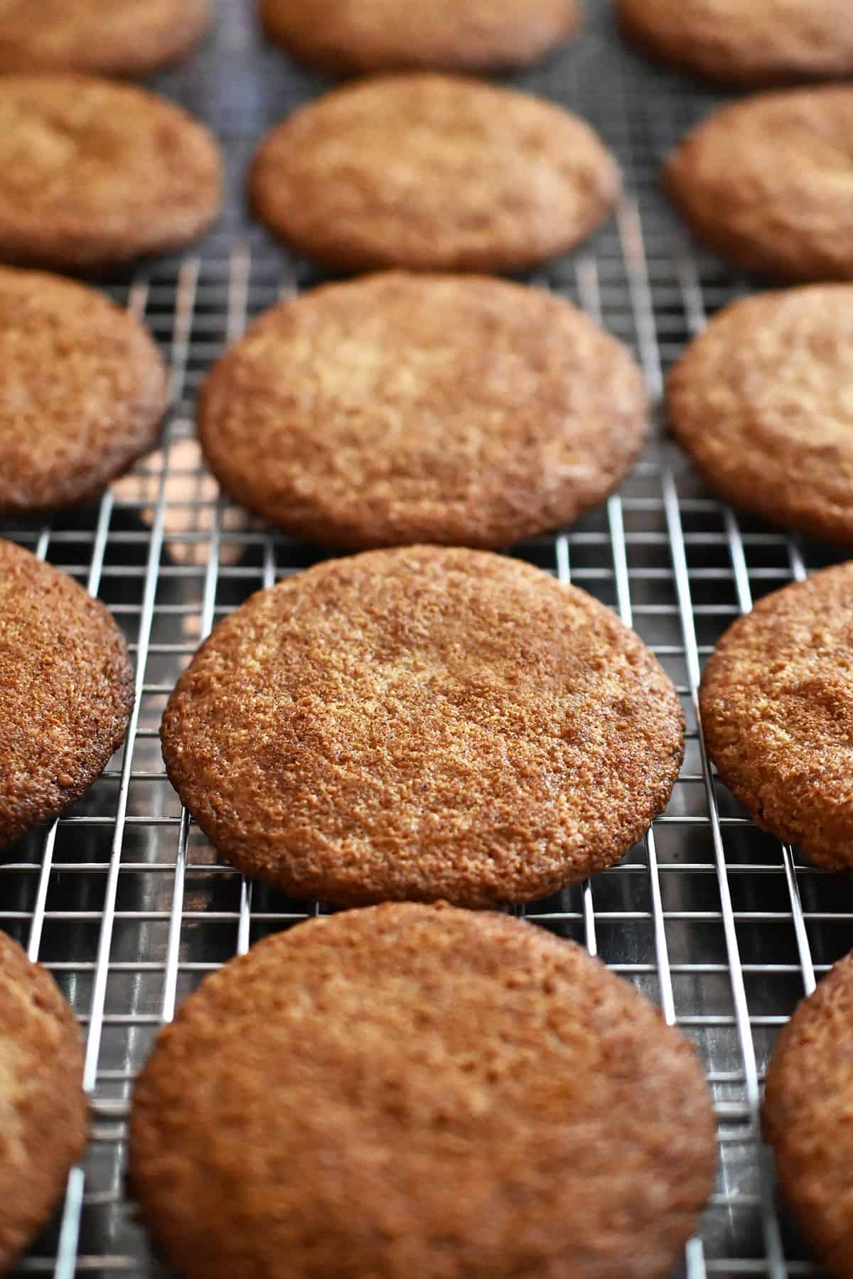 A closeup of freshly baked paleo and gluten free snickerdoodles on a cooling rack.
