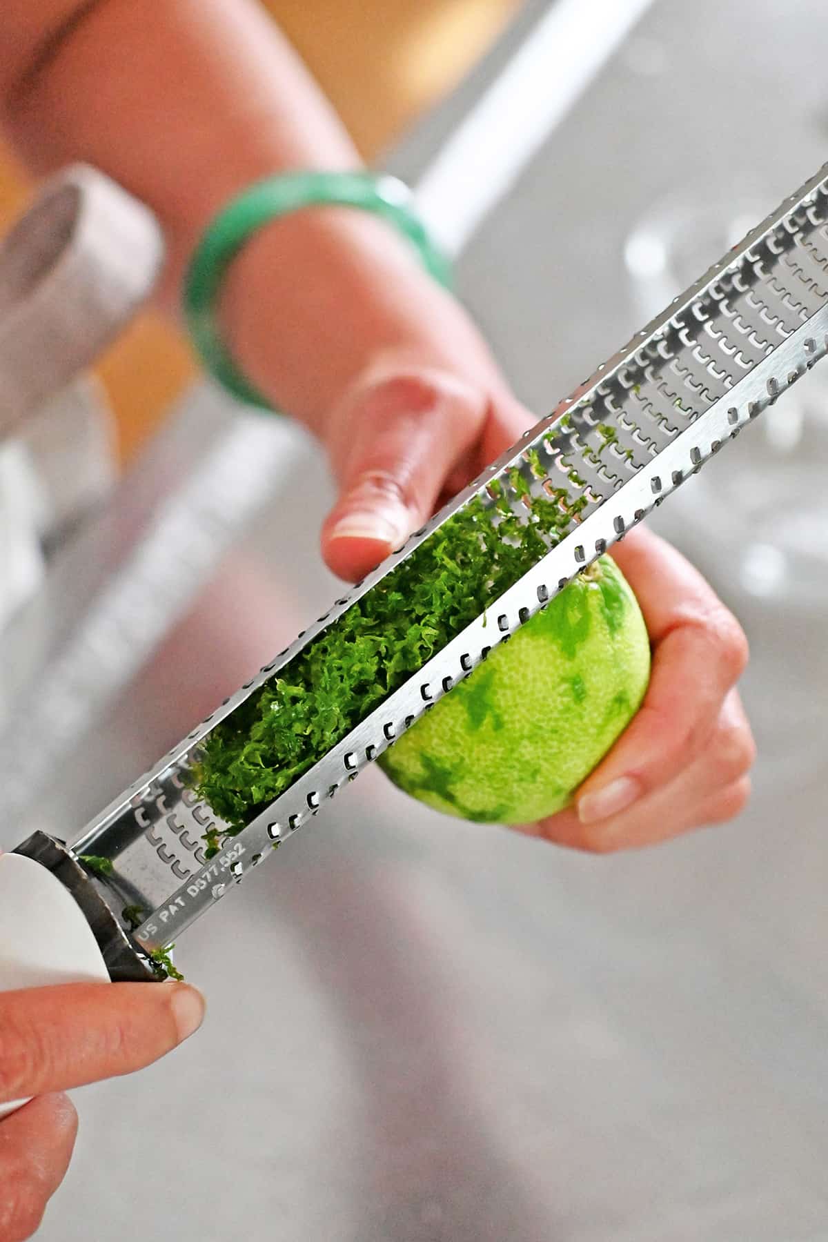 Zesting a lime with a microplane.