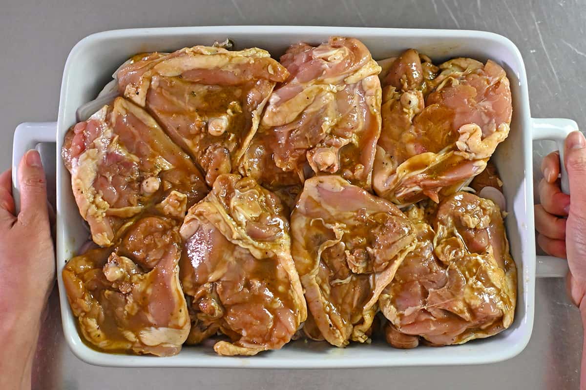 An overhead shot of the chicken thighs in the casserole dish about to be placed in the oven.