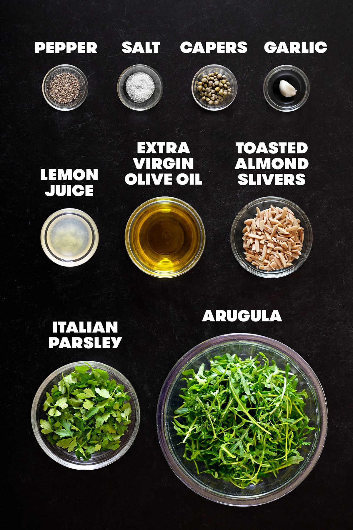 An overhead shot of the ingredients needed to make homemade arugula pesto.