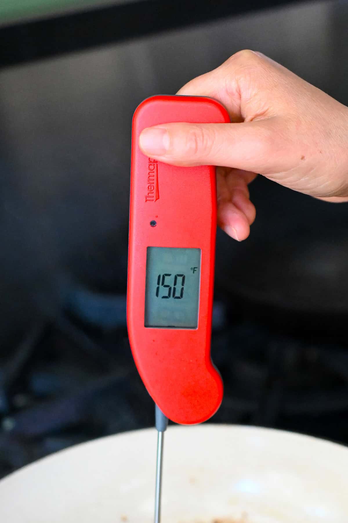 A red instant read thermometer shows 150°F on the display.
